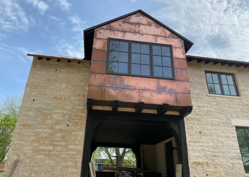 Copper metal panel facade on a stone building for Skylight Installation in Maywood